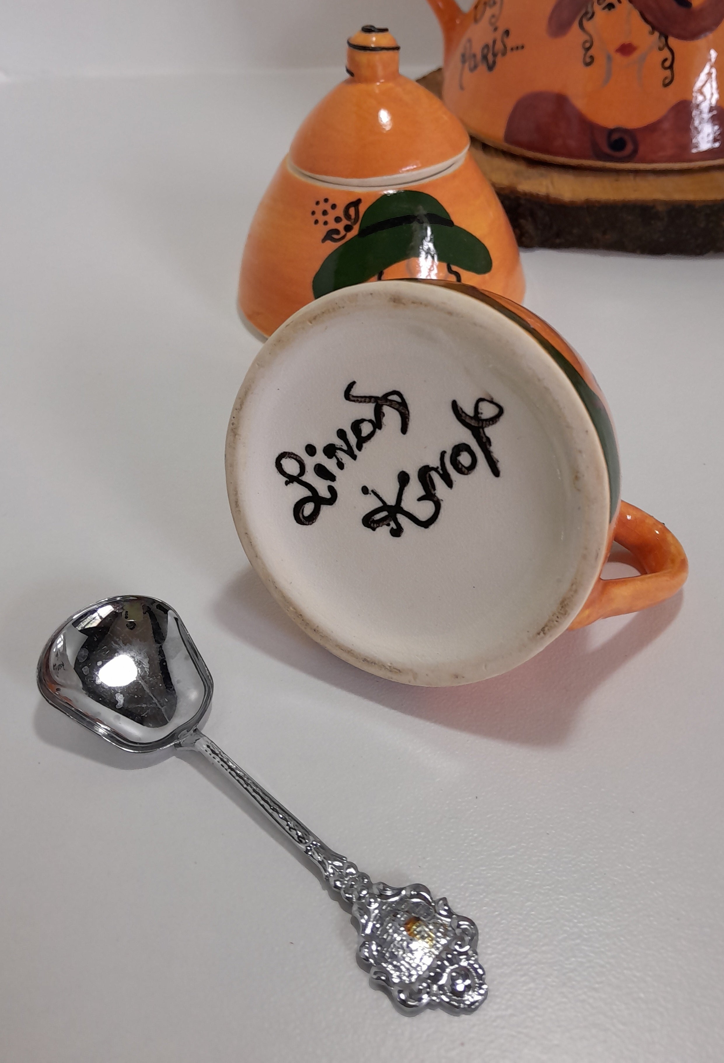3 Piece Hand-painted Glazed Pottery Tea Set in a Vibrant Orange Colour with Black Trim on Finials and Including a Silver Coloured Sugar Spoon