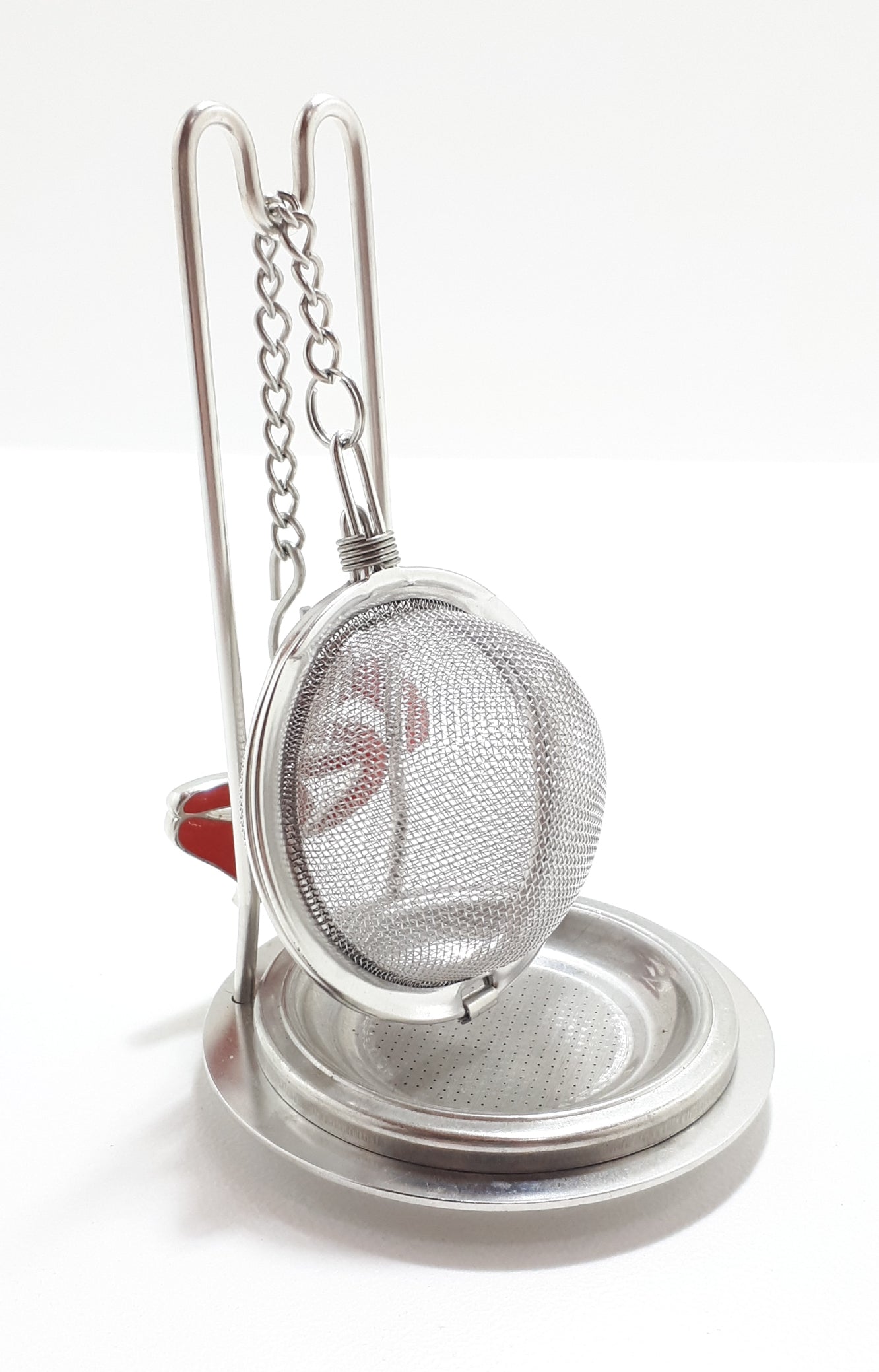 An Unused Tea Ball Strainer / Infuser With Stand, Tray & Red Enamelled “Tea” Charm