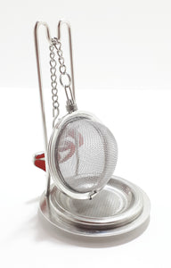 An Unused Tea Ball Strainer / Infuser With Stand, Tray & Red Enamelled “Tea” Charm