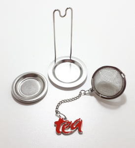 An Unused Tea Ball Strainer / Infuser With Stand, Tray & Red Enamelled “Tea” Charm