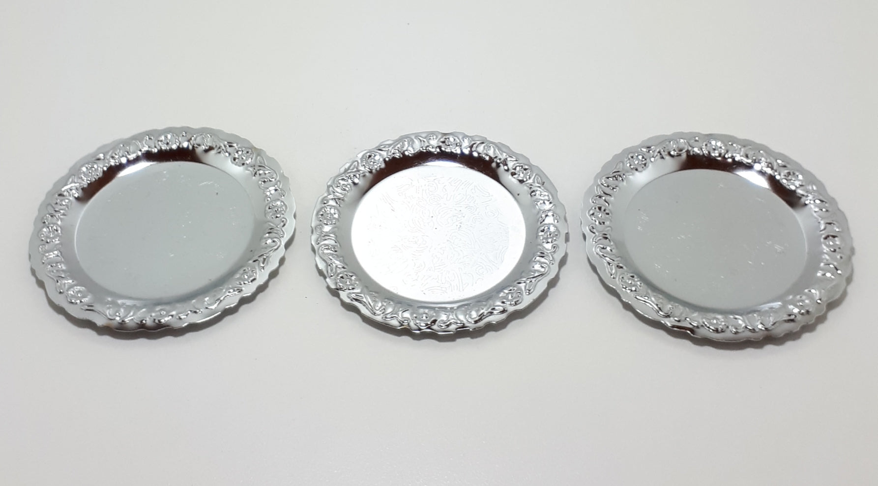 Three Decorative Silver Metal Coasters