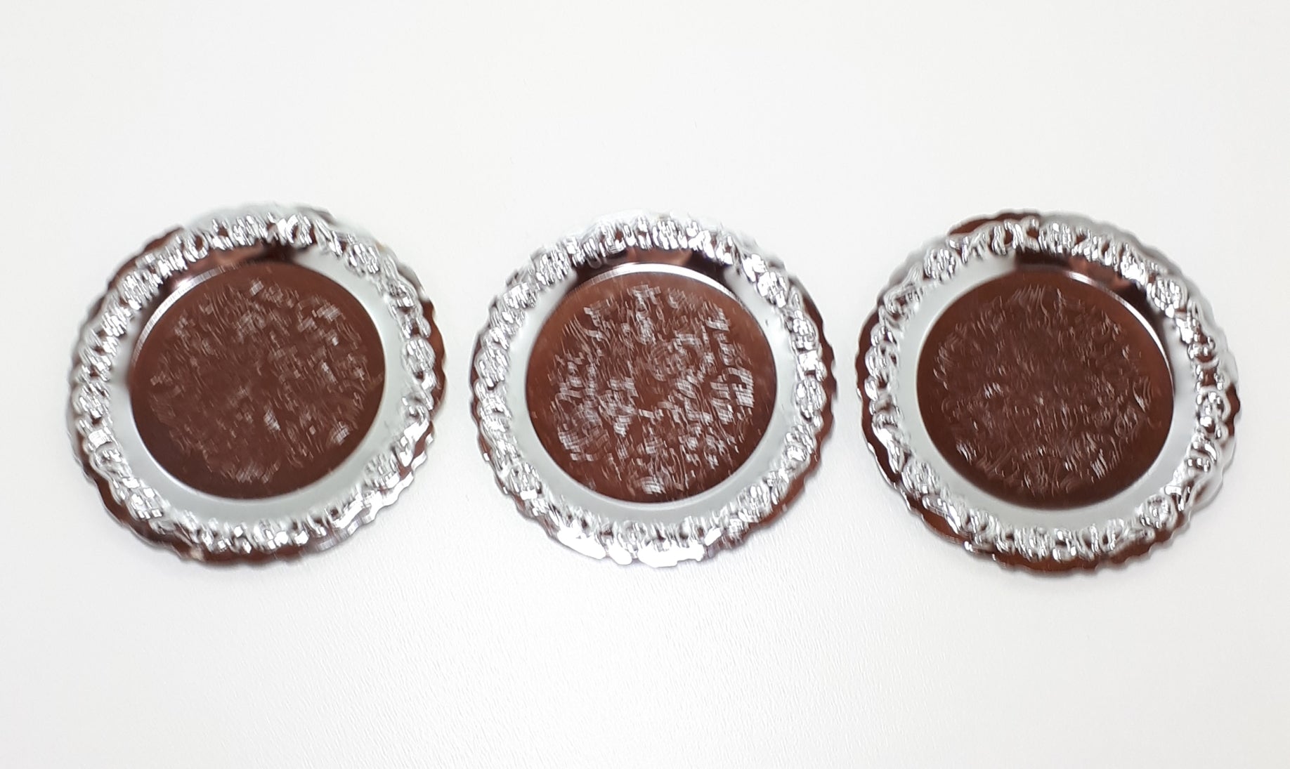 Three Decorative Silver Metal Coasters