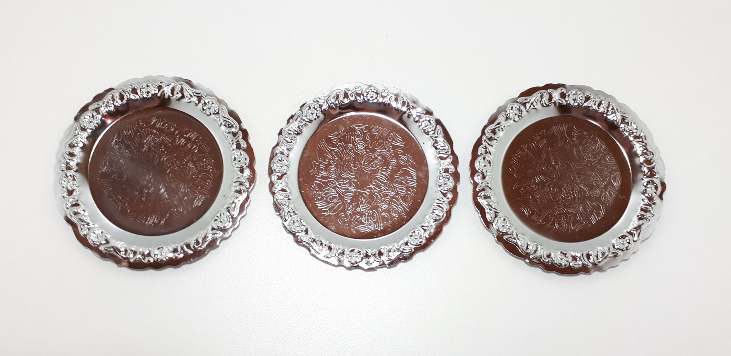Three Decorative Silver Metal Coasters