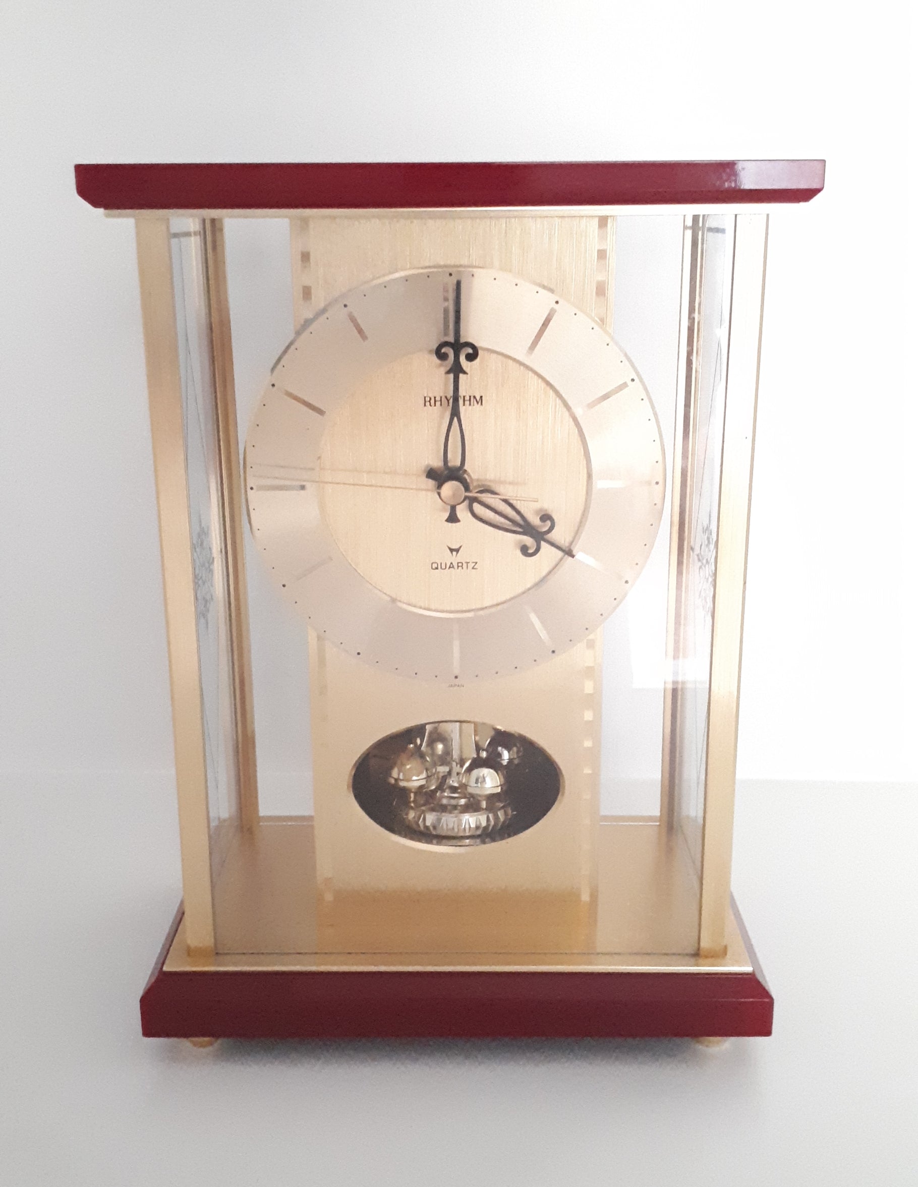Vintage 1980’s Japanese Rhythm Quartz Mantel Clock – Brass, Maroon Bakelite, Glass & Perspex With Wheel Motion
