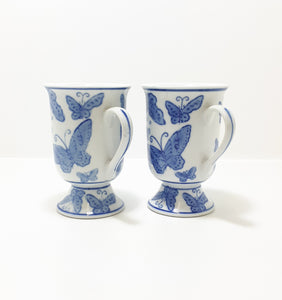 Pair Of Blue & White Footed Coffee Mugs With Butterfly Decoration