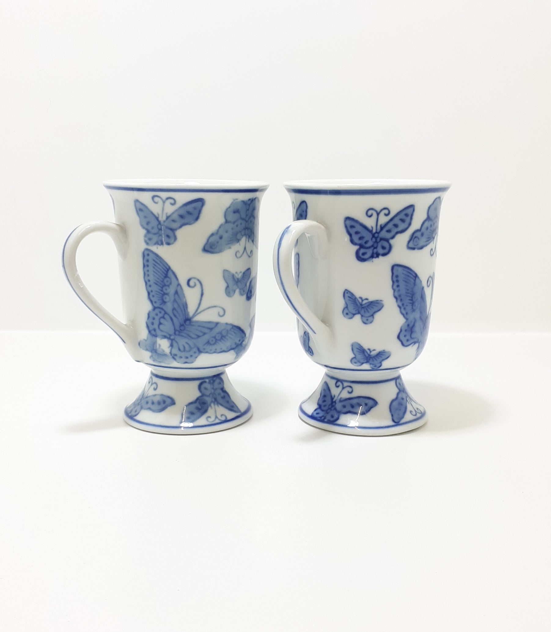 Pair Of Blue & White Footed Coffee Mugs With Butterfly Decoration