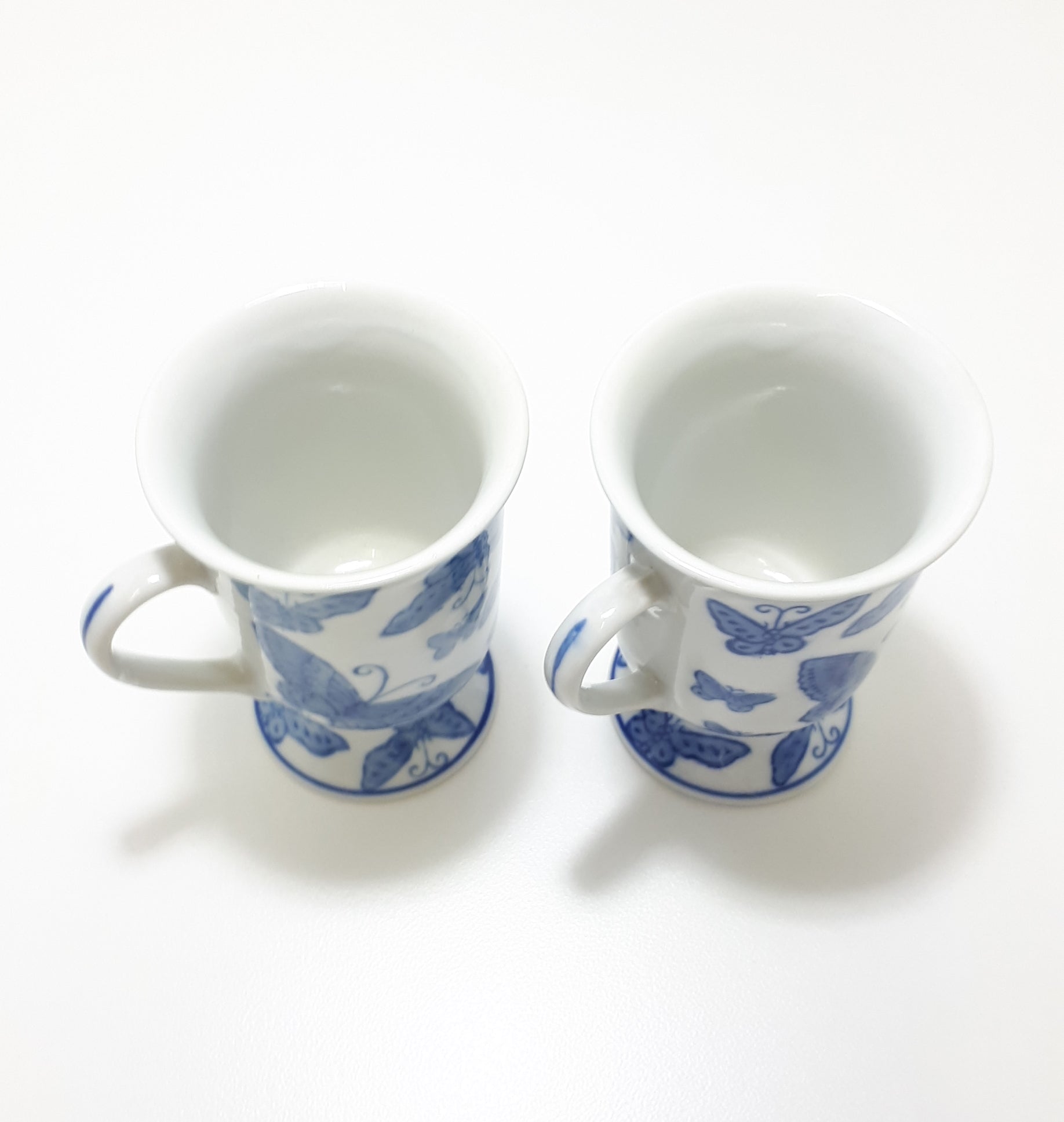 Pair Of Blue & White Footed Coffee Mugs With Butterfly Decoration