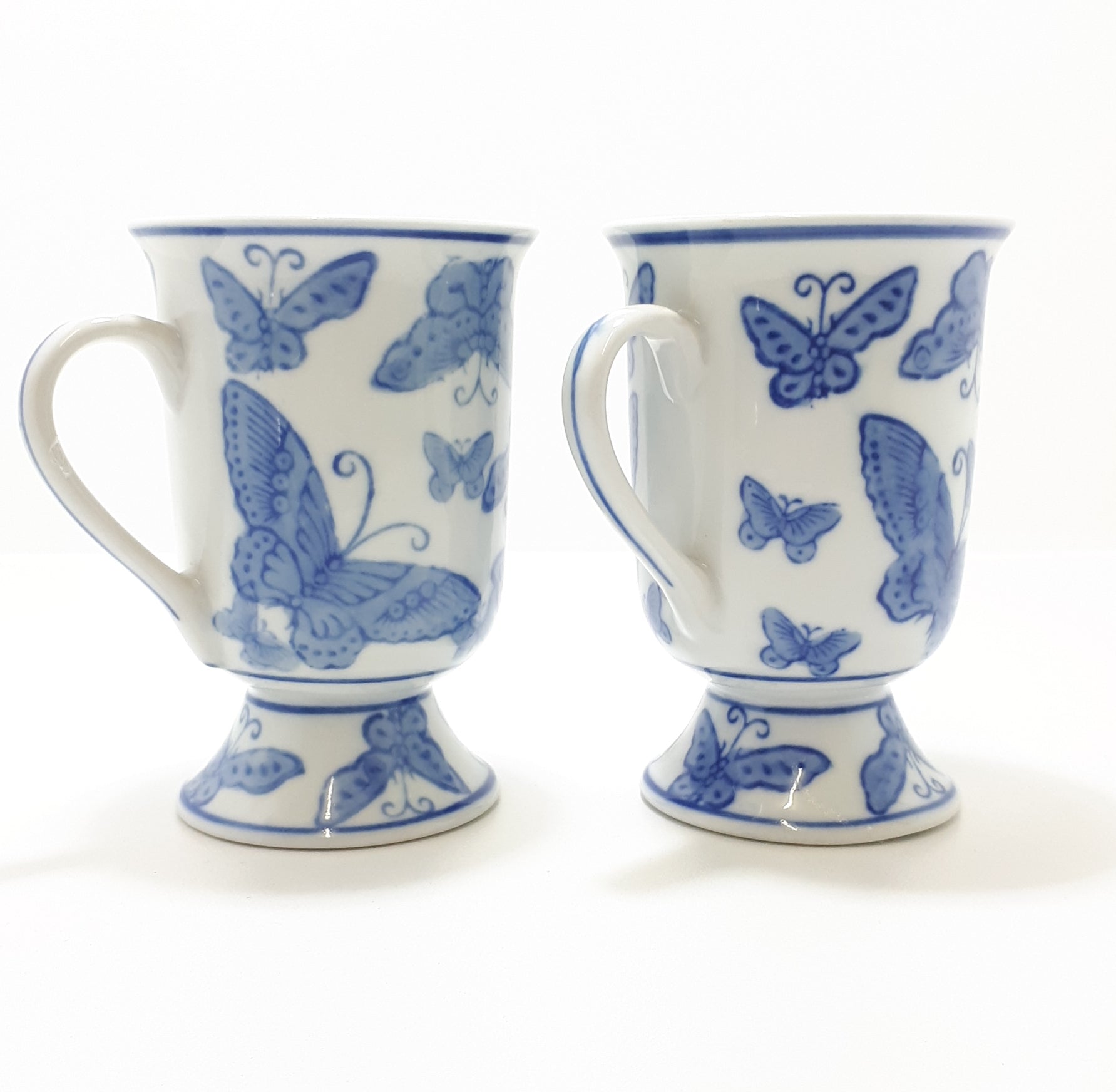 Pair Of Blue & White Footed Coffee Mugs With Butterfly Decoration