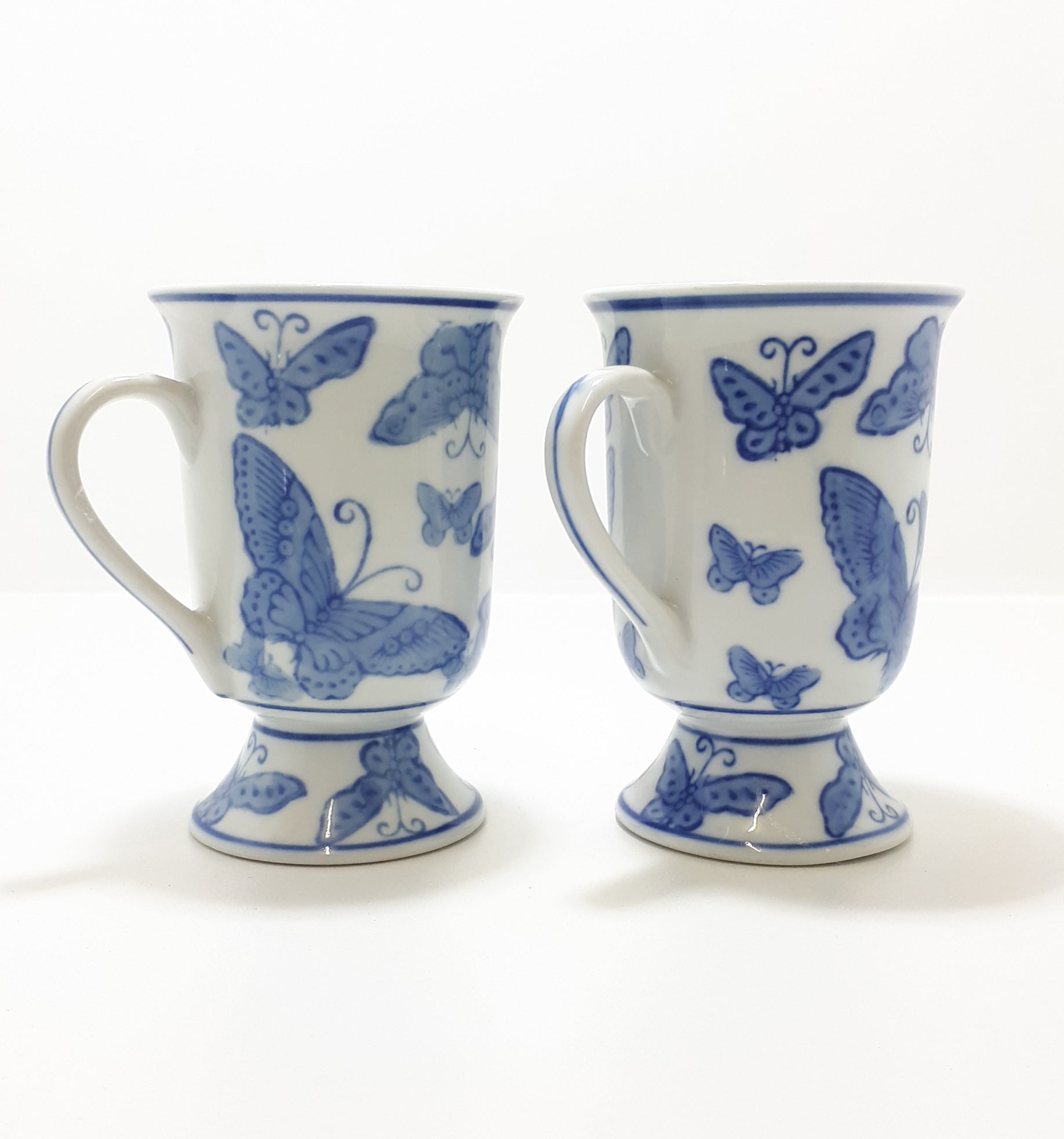 Pair Of Blue & White Footed Coffee Mugs With Butterfly Decoration