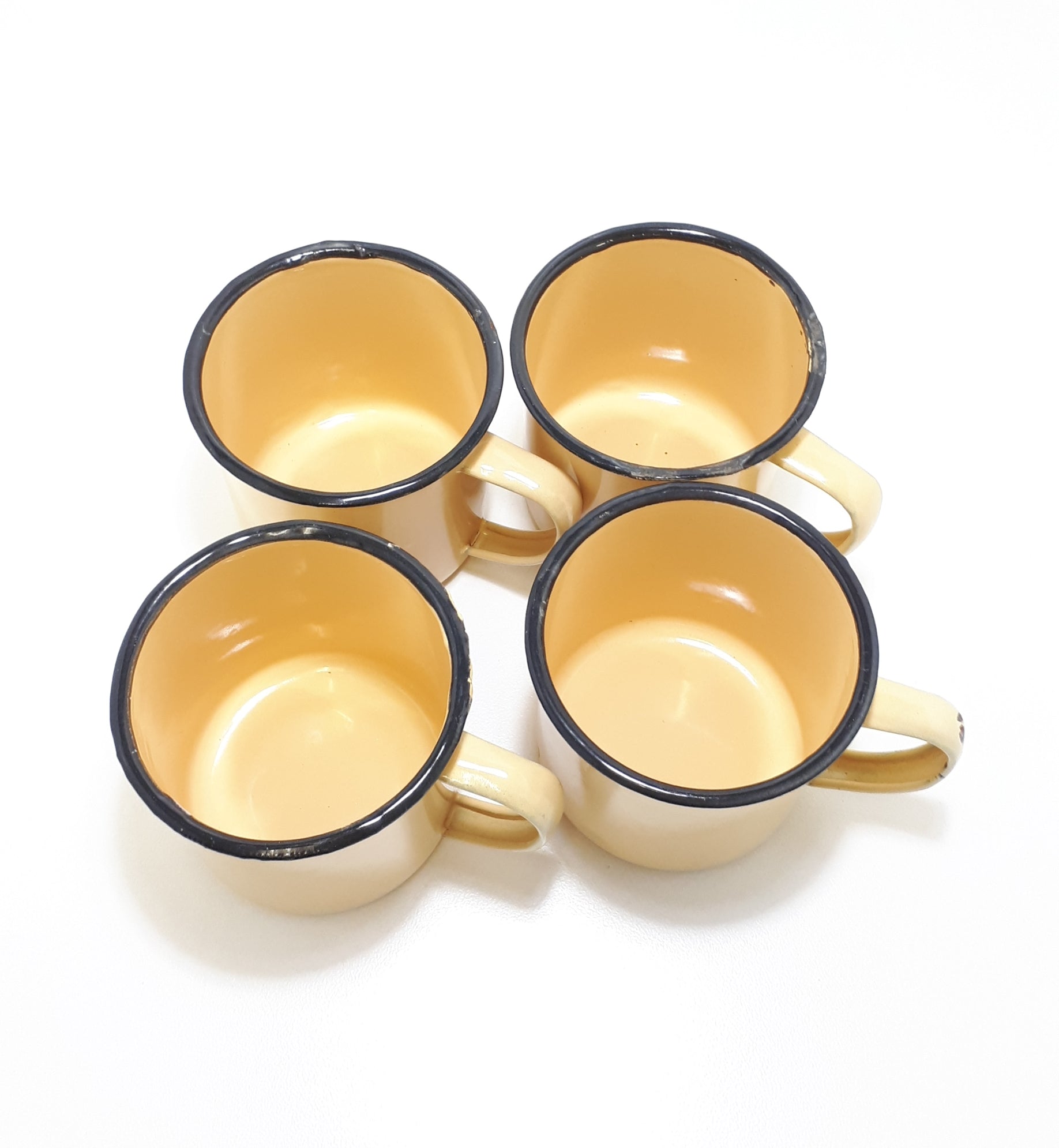 Set Of Four Yellow Vintage Enamel Mugs With Broad Black Rim