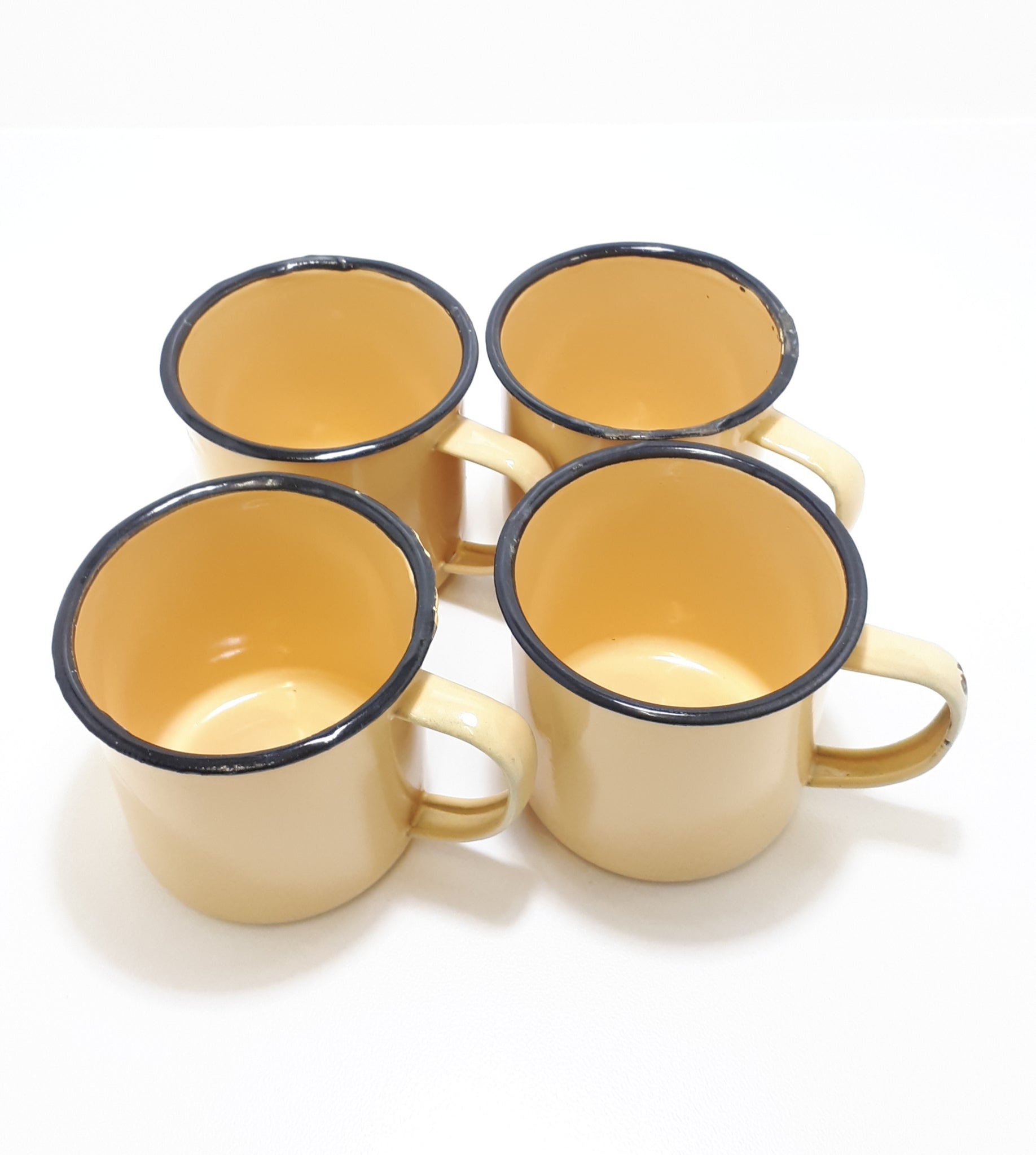 Set Of Four Yellow Vintage Enamel Mugs With Broad Black Rim
